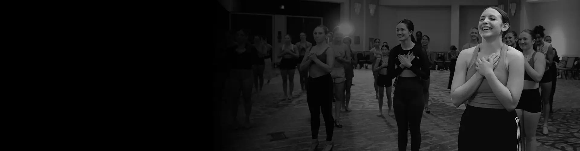 Smiling dancers with hands on their hearts at DanceForward