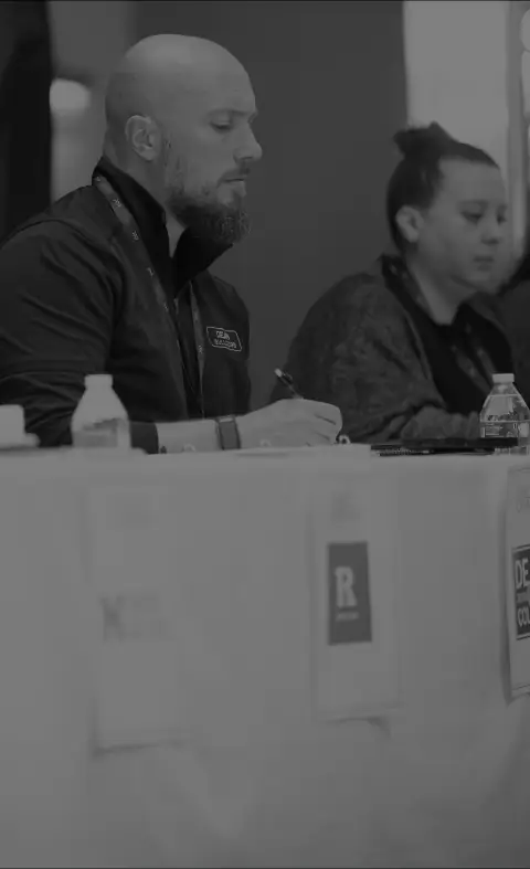 Industry partners reviewing dancers at an audition table