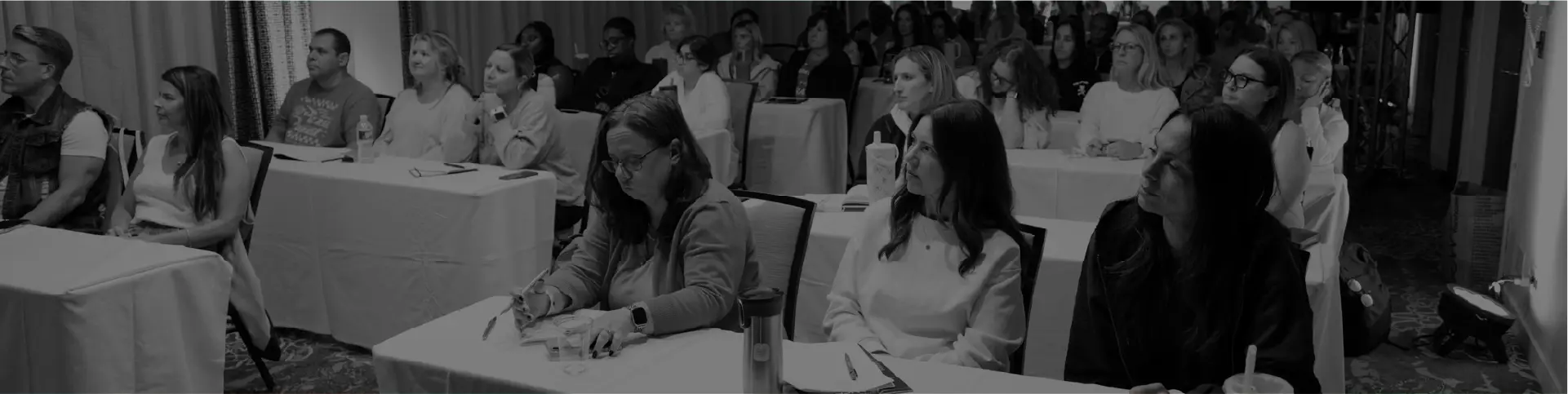 Supporters seated together, taking notes during a DanceForward Supporter Series session