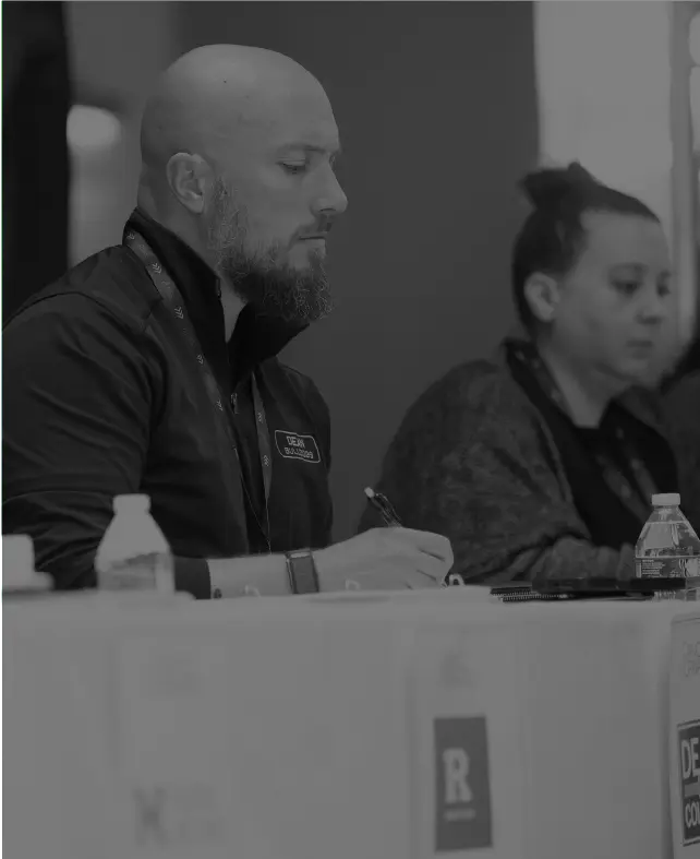 Industry partners reviewing notes together at a table