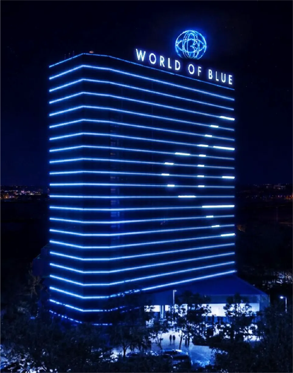 The World of Blue hotel tower lit in blue at night