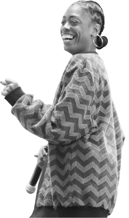DanceForward faculty member laughing with a microphone in hand